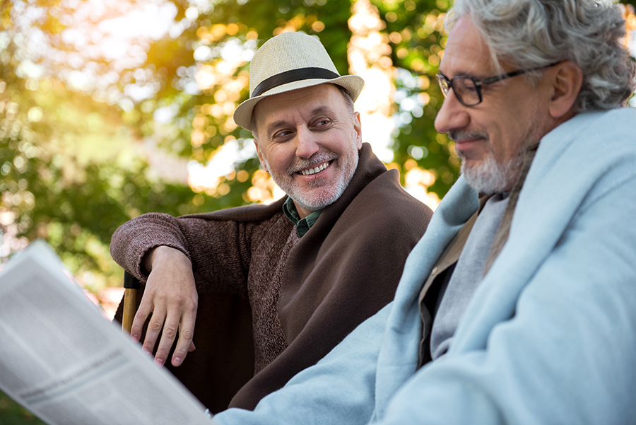 Man with family member chatting about hospice vs. palliative care options