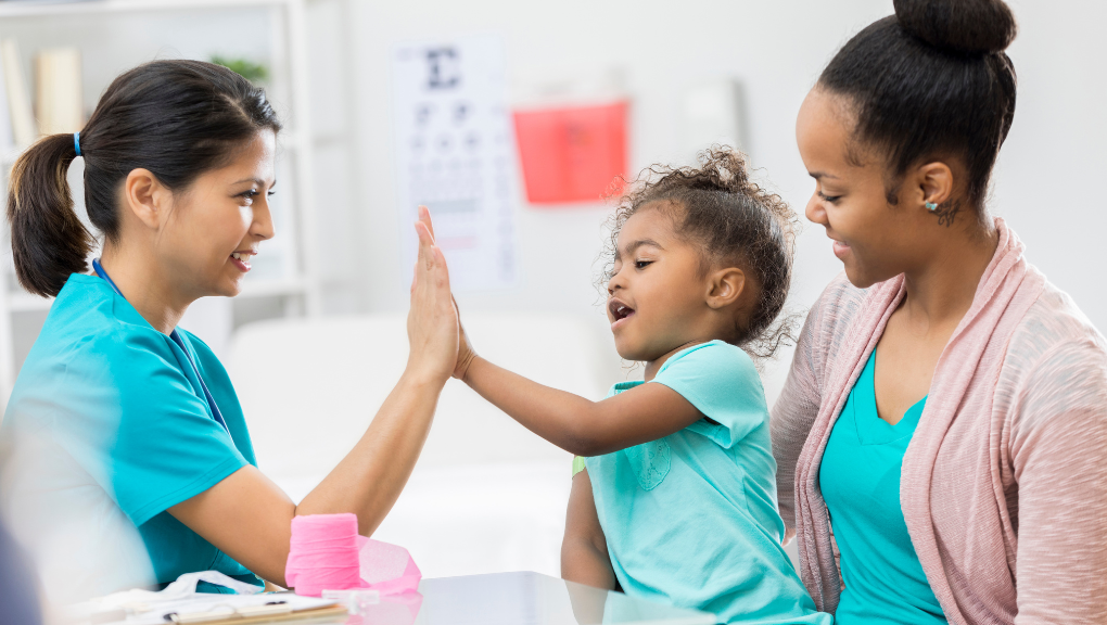 child high-fiving nurse caregiver after parent decides putting your child in hospice